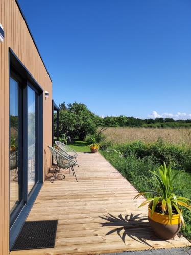 une passerelle en bois avec un banc et des plantes dessus dans l'établissement La Bulle Bigoudène, à Plobannalec-Lesconil