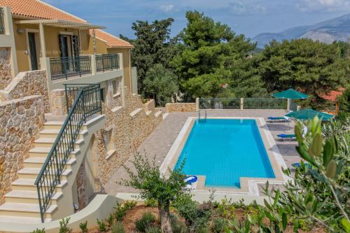 a villa with a swimming pool and a house at Ionian Vista Villas in Argostoli