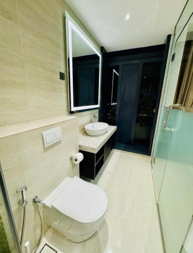 a bathroom with a toilet and a sink and a shower at Star Residence KLCC By Cozy in Kuala Lumpur