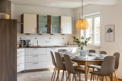a kitchen and dining room with a table and chairs at Step Apartments - Large, Luxurious and Central in Bad Aibling