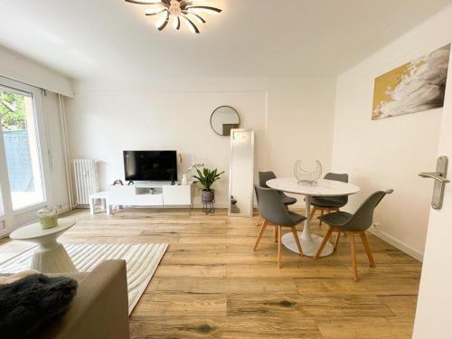 - un salon avec une table, des chaises et une télévision dans l'établissement Charmant studio proche mer, à Roquebrune-Cap-Martin