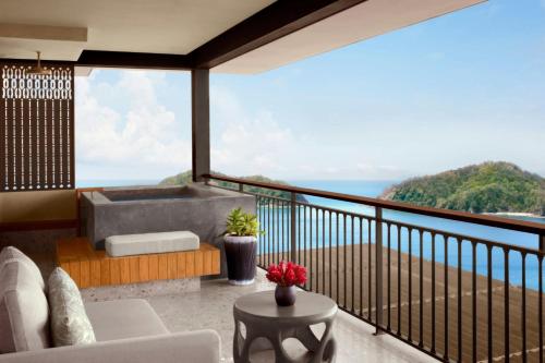 a balcony with a tub and a view of the ocean at Nekajui, a Ritz-Carlton Reserve in Papagayo, Guanacaste