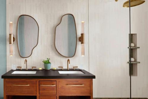 a bathroom with two sinks and two mirrors at Nekajui, a Ritz-Carlton Reserve in Papagayo, Guanacaste