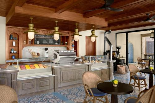 a kitchen with a counter with chairs and tables at Nekajui, a Ritz-Carlton Reserve in Papagayo, Guanacaste