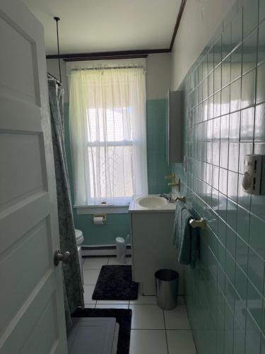 a bathroom with a sink and a toilet and a window at Quiet retreat Atlantic City in Atlantic City