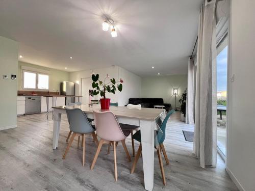 une cuisine et une salle à manger avec une table et des chaises dans l'établissement Maison 6 personnes, à Pétosse