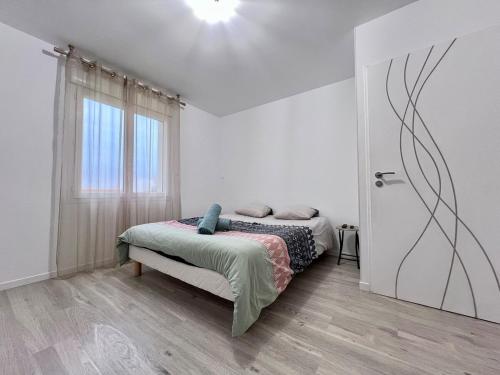 une chambre blanche avec un lit et une fenêtre dans l'établissement Maison 6 personnes, à Pétosse