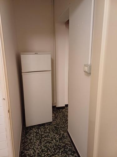 an empty hallway with a white refrigerator in a room at La casa di nonna Angela in Sassello