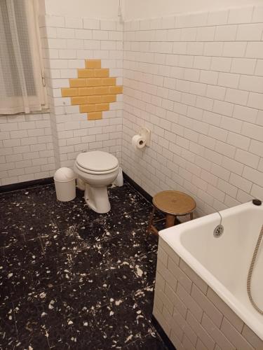 a bathroom with a toilet and a bath tub at La casa di nonna Angela in Sassello