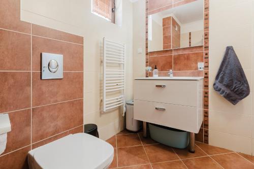 a bathroom with a toilet and a sink and a mirror at Созопол Sozopol- SOZOPOLIS - MORE SUN 2В in Sozopol