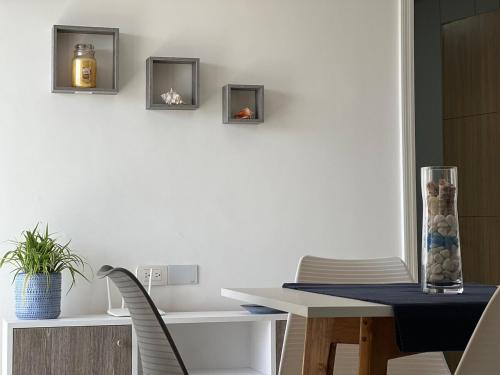 a dining room with a table and a candle on the wall at Playa el Ángel Apartment in Pampatar