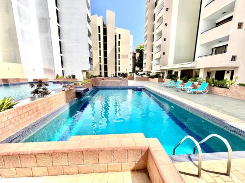 a swimming pool in the middle of a building at Playa el Ángel Apartment in Pampatar