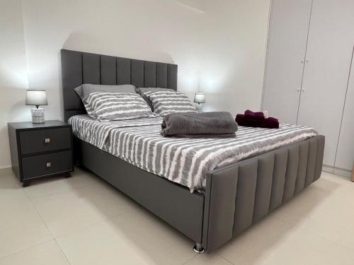 a bedroom with a large bed with a gray frame at Playa el Ángel Apartment in Pampatar
