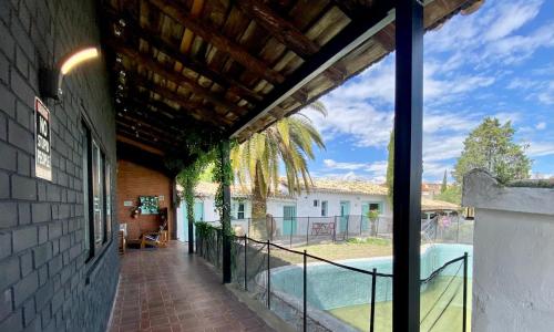 a house with a balcony with a swimming pool at Casa Virgen de la Vega in Añover de Tajo
