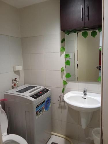 a small bathroom with a sink and a toilet at Sea Residences david in Manila