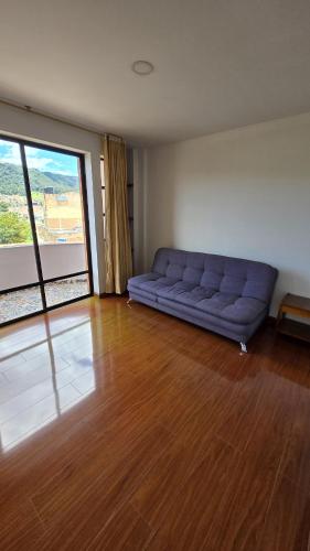 a living room with a blue couch in a room at Hotel Imperial in Chiquinquirá
