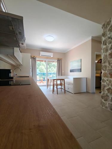 a kitchen and living room with a table and a dining room at Katalyma Thalassa in Ixia