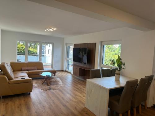 a living room with a couch and a table at Villa Hilden in Hilden