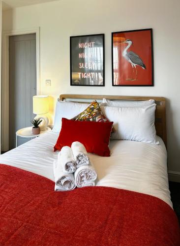 a bedroom with a bed with towels on it at Ideal Wigan Base - 1BR for Cosy Stays in Wigan