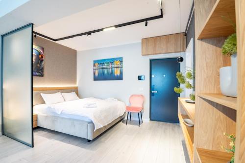 a bedroom with a bed and a desk and a chair at Studio President 80 in Craiova