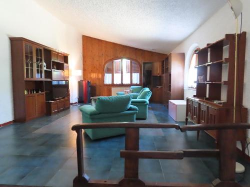 a living room with a green couch and a table at Rosso Papavero Home in Borgo San Lorenzo