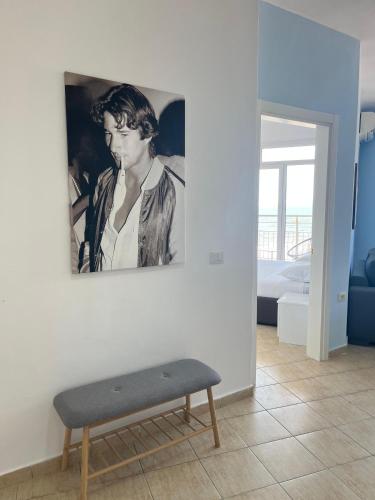 a room with a bench and a painting on the wall at Beachfront Marilyn in Durrës