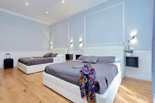 a bedroom with two beds and a tv at St. Peter Vatican Rooms in Rome
