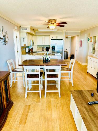 a kitchen and dining room with a table and chairs at The Salty Breeze - 2 Ocean Front Master's - Steps to the Beach in Myrtle Beach