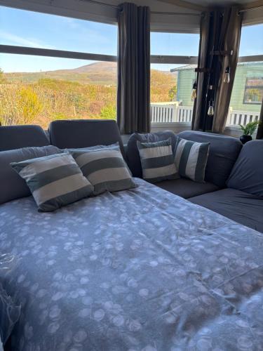 a blue couch with pillows on top of it at 148 Port Haverigg in Millom