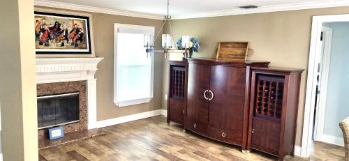 a living room with a wine cabinet and a fireplace at Sarasota Charm in Sarasota