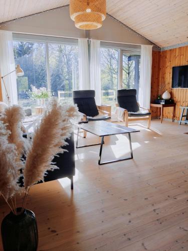 a living room with two chairs and a table at EchoBay nr 2 - child-friendly house close to the beach in Jerup