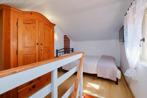 ein kleines Schlafzimmer mit einem Bett und einer Treppe in der Unterkunft Cozy Holiday Home Punta Kriza in Punta Križa