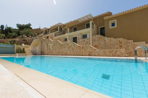 a swimming pool in front of a building at Ionian Vista Villas in Argostoli