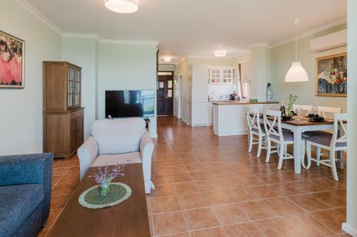 a living room and kitchen with a couch and a table at Sozopol Созопол- SOZOPOLIS -MORE SUN 2А- in Sozopol