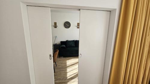a living room with a couch and a mirror at bookVienna "JiM" Apartments in Vienna