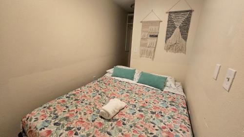 a small bedroom with a bed with a comforter at Lovely 1 Bedroom Condo in the Heart of Seattle! in Seattle