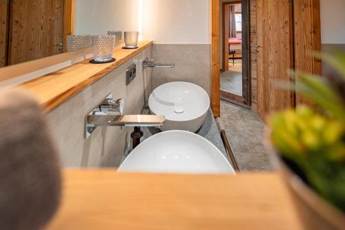 a bathroom with a white toilet and a counter at Luxus Chalet im Allgäu - Zirbenholz Schlafzimmer - Terrasse mit Bergblick - Infrarotkabine in Blaichach