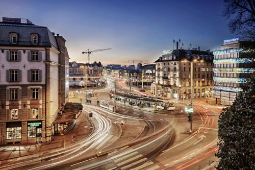 a city with buildings and traffic on a street at night at Zürich Central Station Apartment, 2 bedroom & Sofabed in Zürich