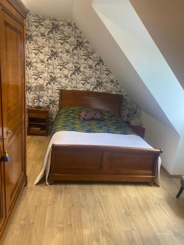 a bedroom with a bed in a attic at Chambre des Tours 2 in Mont-Saint-Éloi