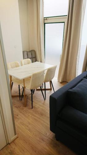 a living room with a table and a couch at HYPER CENTRE AVEC JARDIN 47m2 COSY in Boulogne-sur-Mer