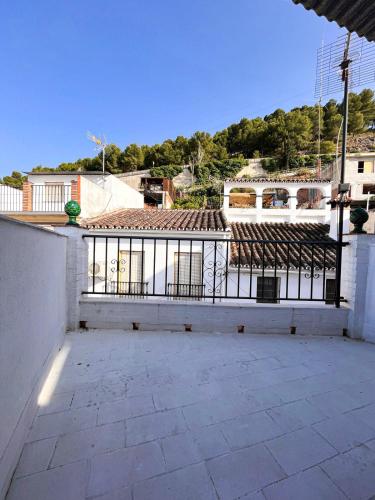a building with a fence on the side of it at Casa Rincón de Monda in Monda