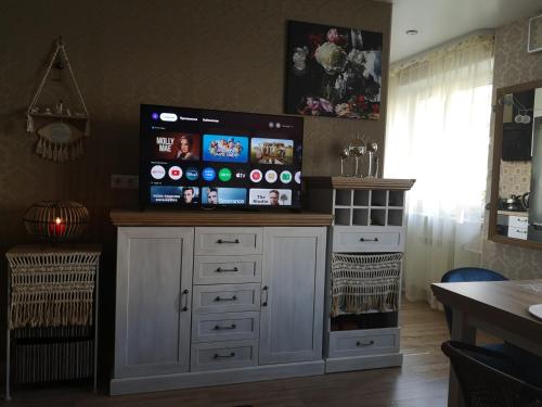 a large entertainment center with a flat screen tv on top at Narva Boho Home in Narva