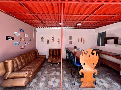 a living room with a couch and a table at Hospedaje Casa Azul in Mexico City