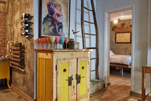 a room with a wooden cabinet and a ladder at Apartament Art Cluj in Cluj-Napoca