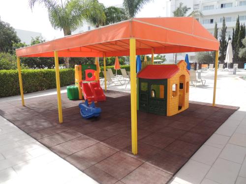 a playground with a tent and a play set at Anesis Hotel in Ayia Napa
