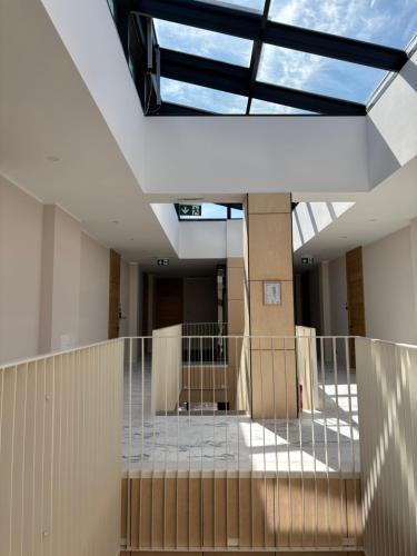 a hallway of a building with a glass ceiling at Albatross 949 by the Sea in Ķesterciems