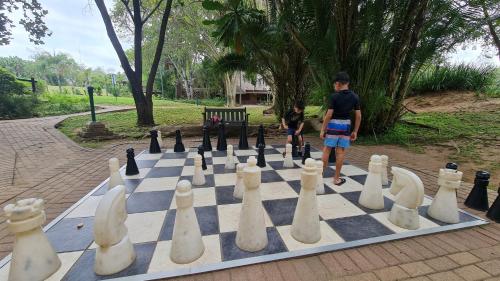 a man and a child playing chess on a chess board at Kruger Park Lodge 243 in Hazyview