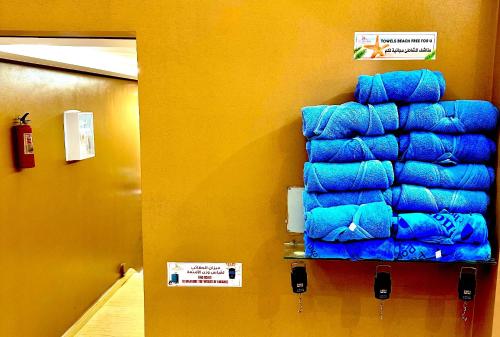 a stack of blue towels hanging on a wall at Hotel apartment america in Dakhla