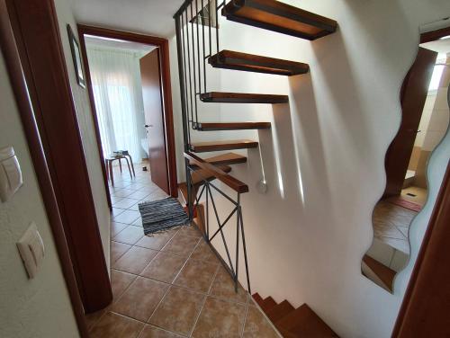 a hallway with a spiral staircase in a house at Villa Veta, Nikiti beach in Nikiti