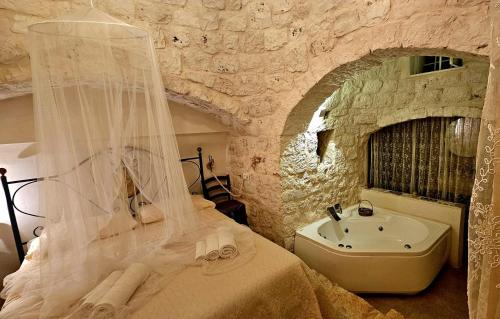 a bedroom with a bed and a sink at Villa Trullo Septis in Ostuni
